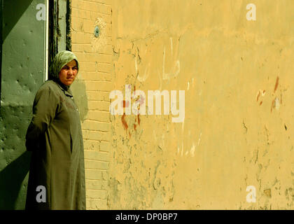 Mar 07, 2006; Ad Dawr, Saluhidin, IRAQ; An Iraqi woman looks on for a search of a neighborhood in Ad Dawr, Iraq, for an insurgent sniper who wounded an American soldier. The sniper shot and wounded one American soldier before getting away. The soldier lived and was evacuated to Germany. Ad Dawr is approximately 15 miles from Tikrit and 15 miles from Samarra. 2nd of the 9th Cavalry  Stock Photo