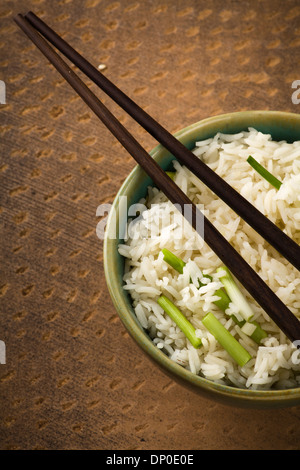 Bowl of lemon Rice with wild garlic on stone background Stock Photo