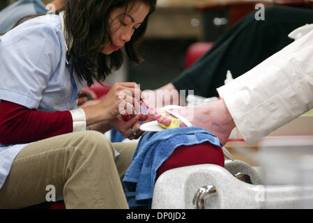 Mar 22, 2006; Plano, TX, USA; Royal Nails manicurist KIM NGUYEN of Garland, Tex. gives a manicure to a customer at the new Wal-Mart SuperCenter in Plano, TX. The store at 1700 Dallas Parkway is the company's 105th location in North Texas and features more than 2,000 items not sold at other Wal-Mart stores, including Dom Perignon for $145.37, hundreds of organic fruit and vegetables Stock Photo