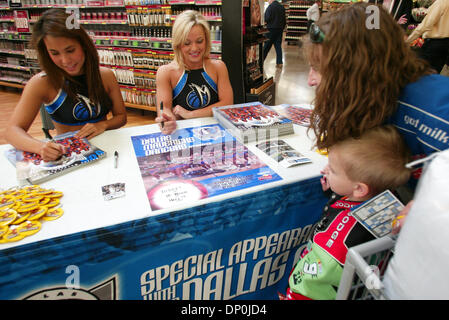 Mar 22, 2006; Plano, TX, USA; BRANDON NEWMAN, 5, of Little Elm, TX gets an autographed photo from Dallas Mavericks' cheerleader KIM TONG, left, of Dallas at the new Wal-Mart SuperCenter in Plano, TX.  Brandon's mother COLLETTE NEWMAN, right, and Mavericks' cheerleader KANDI HARRIS of Dallas share the moment with him. The store at 1700 Dallas Parkway is the company's 105th location  Stock Photo