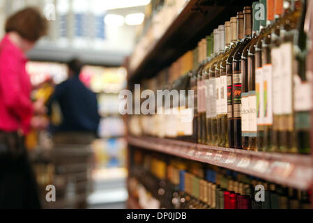 Mar 22, 2006; Plano, TX, USA; A shopper chooses a California wine at the new Wal-Mart SuperCenter in Plano, TX. The store at 1700 Dallas Parkway is the company's 105th location in North Texas and features more than 2,000 items not sold at other Wal-Mart stores, including Dom Perignon for $145.37, hundreds of organic fruit and vegetables, and a new store layout with wider aisles, al Stock Photo