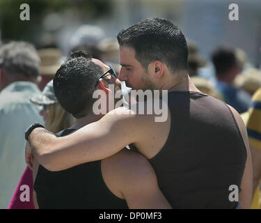 Mar 27, 2006; Lake Worth, FL, USA; Danny Pereira (right) hugs his friend Osmany Caballero (left) while waiting to enter the 13th Annual PrideFest of the Palm Beaches held at Bryant Park in Lake Worth.   Mandatory Credit: Photo by Damon Higgins/Palm Beach Post/ZUMA Press. (©) Copyright 2006 by Palm Beach Post Stock Photo