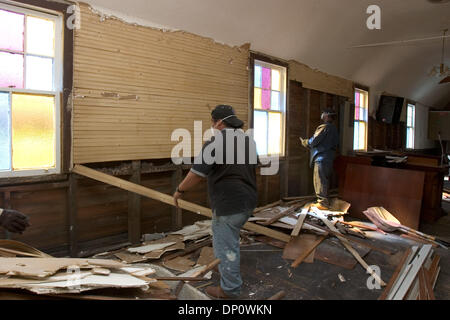 Apr 05, 2006; New Orleans, LA, USA; Edgar Joseph (right), from New Orleans, commutes weekly from Houston, where his family evacuated, to work on a crew gutting a church in New Orleans damaged by Hurricane Katrina. Alejandro Palma, a Honduran from New York City, came down to New Orleans to find work. He shares a one-bedroom apartment across the river with two other Hondurans on the  Stock Photo