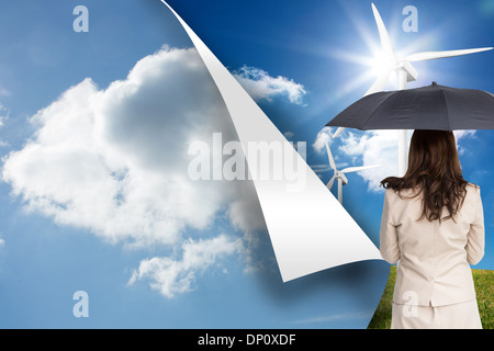 Composite image of rear view of classy businesswoman holding umbrella Stock Photo