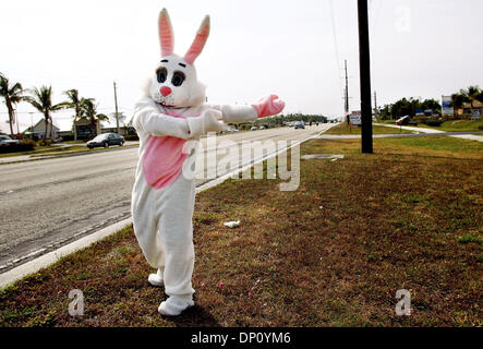 Apr 08, 2006; Stuart, FL, USA; The Easter Bunny, aka Louie Page of Port St. Lucie, gestures as a hitchhiker while he promotes his new gift card shop along US Federal Hwy 1 in Stuart on Saturday. Page decided to rent the bunny suit, at $125 each day for 2 days to entice passing drivers to purchase his stock of Easter cards. He plans to wave, blow kisses and egg on motorists through  Stock Photo