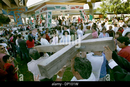 Apr 09, 2006; San Diego, CA, USA; Members of Our Lady of Guadalupe Church carry the cross that commemorates Palm Sunday during Palm Sunday Mass at Chicano Park in the Barrio Logan section of San Diego. Mandatory Credit: Photo by Howard Lipin/SDU-T/ZUMA Press. (©) Copyright 2006 by SDU-T Stock Photo