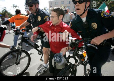 Apr 09, 2006; San Diego, CA, USA; Two San Diego Police officers on bicycles remove an anti-immigration protestor who was trying to incite the crowd of pro immigration marchers during their march on Sunday. Mandatory Credit: Photo by John Gibbins/SDU-T/ZUMA Press. (©) Copyright 2006 by SDU-T Stock Photo