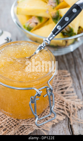 Homemade Pineapple Jam in a small glass with fresh fruit pieces Stock Photo
