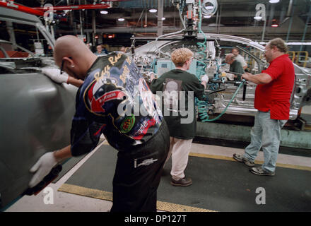 Apr 13, 2006; Detroit, MI, USA; (FILE PHOTO: Exact date 07-29-2001) DaimlerChrysler to Sell Manufacturing Assets from Sterling Heights Assembly Plant. Pictured: In the DaimlerChrysler Sterling Heights Assembly Plant, new doors for the Chrylser Sebring Sedan are moved into place by James Beasley, from the Sterling Heights Stamping plant, visiting, inspecting parts, helping door inst Stock Photo