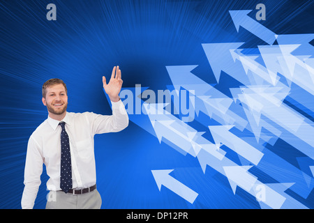 Composite image of handsome businessman with suitcase waving Stock Photo