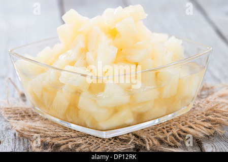 Canned Pineapple on vintage wooden background (close-up shot) Stock Photo