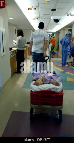 Apr 14, 2006; Rochester, MN, USA; Jesse Carlsen pulls his twin daughters in a wagon through the halls of St. Mary's Hospital to visit the hospital chapel. Conjoined twins, Isabelle and Abbigail Carlsen, will be separated May 12 at Mayo Clinic. Mandatory Credit: Photo by Joey McLeister/Minneapolis Star T/ZUMA Press. (©) Copyright 2006 by Minneapolis Star T Stock Photo