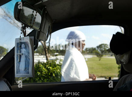 Apr 14, 2006; Delray Beach, FL, USA; One of the mourning women walks past a truck with an image of Christ and a rosary hanging from the rear-view mirror as she prepares to embark on a living Stations of the Cross with other members of Our Lady of Perpetual Help Catholic Haitian Mission in remembrance of Good Friday.  Mandatory Credit: Photo by Chris Matula/Palm Beach Post/ZUMA Pres Stock Photo