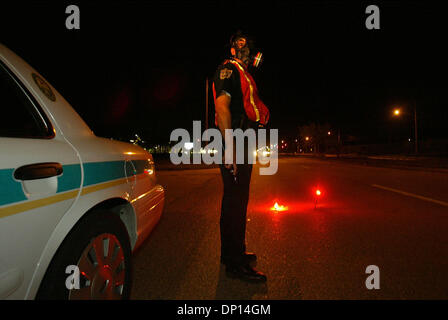 Apr 18, 2006; Boynton Beach, FL, USA; An unidentified Palm Beach County Sheriff's Deputy stands guard on Hypoluxo Blvd. just east of Jog Rd., wearing a gas mask as a precaution, after a house on Hypoluxo Farms Rd. exploded Tuesday evening, April 18, 2006 in suburban Boynton Beach. Sheriff's Office personnel blocked off numerous side streets to keep bystanders back. The house was co Stock Photo