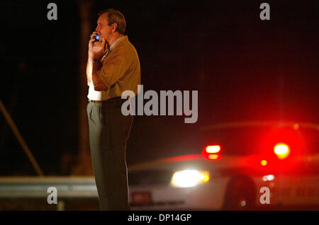 Apr 18, 2006; Boynton Beach, FL, USA; Palm Beach County Sheriff Ric Bradshaw stands on Hypoluxo Blvd. just east of Jog Rd. waiting to set up a command post after a house on Hypoluxo Farms Rd. exploded Tuesday evening, April 18, 2006 in suburban Boynton Beach. Sheriff's Office personnel blocked off numerous side streets to keep bystanders back. The house was completely destroyed and Stock Photo