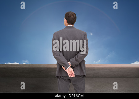 Composite image of rear view of classy businessman posing Stock Photo