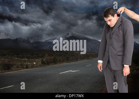 Composite image of businessman hanging Stock Photo