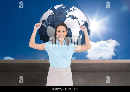 Composite image of victorious stylish businesswoman posing Stock Photo