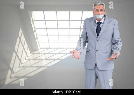 Composite image of businessman gagged with adhesive tape on mouth Stock Photo