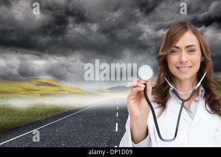 Composite image of happy doctor using stethoscope Stock Photo