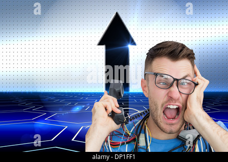 Composite image of frustrated computer engineer screaming while on call in front of open cpu Stock Photo