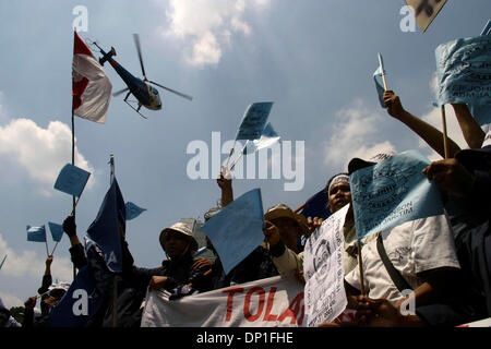 May 01, 2006; Jakarta, INDONESIA; A police helicopter passes above the workers protest in front of Hotel Indonesia. Thousands of workers from various regions rallied for marking the International Workers Day Ð May Day. Beside protest of the revisions to labor law, they also demand government to declare May Day as a national holiday. Police at the demonstration kept close watch for  Stock Photo