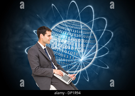 Composite image of businessman using laptop Stock Photo
