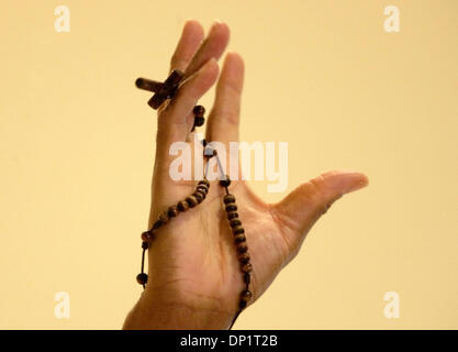 May 07, 2006; Delray Beach, FL, USA; Father Jules Campion, from Port-au-Prince, lifts his hand holding a Rosary as he preaches to Charismatic Christians worshiping  at  Delray Beach's Our Lady of Perpetual Hope on Sunday for their statewide convention.  Mandatory Credit: Photo by Lannis Waters/Palm Beach Post/ZUMA Press. (©) Copyright 2006 by Palm Beach Post Stock Photo