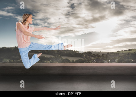 Composite image of woman doing dance pose Stock Photo