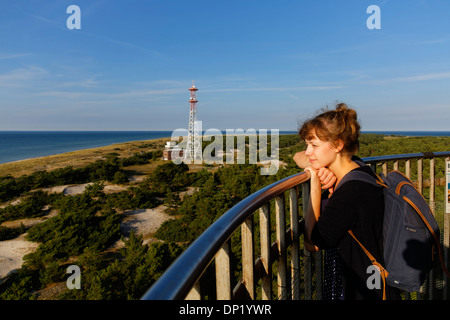 Young woman looking out from the Leuchtturm Darßer Ort lighthouse, Darß, Western Pomerania Lagoon Area National Park Stock Photo