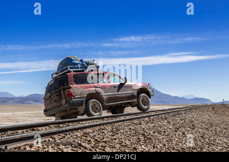 Car crossing railroad tracks, Altiplano, Andean Plateau, Andes, Bolivia Stock Photo