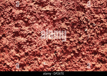 Texture of red bumpy cement wall close up Stock Photo