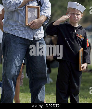 May 29, 2006; San Antonio, TX, USA; Seth Blocker, 7, attends Memorial Day services Monday morning May 29, 2006 at Ft. Sam Houston National Cemetery with his uncle Dennis Blocker. Seth is holding a picture of his great-great-grandfather and Dennis is holding a picture of his great-great-grandfather. On Seth's uniform are his great-great-grandfather's service ribbons. Mandatory Credi Stock Photo