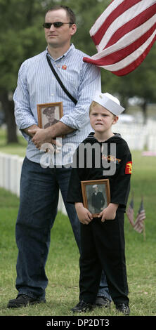 May 29, 2006; San Antonio, TX, USA; Seth Blocker, 7, attends Memorial Day services Monday morning May 29, 2006 at Ft. Sam Houston National Cemetery with his uncle Dennis Blocker. Seth is holding a picture of his great-great-grandfather and Dennis is holding a picture of his great-great-grandfather. On Seth's uniform are his great-great-grandfather's service ribbons. Mandatory Credi Stock Photo