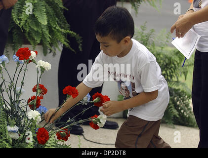 May 29, 2006; San Antonio, TX, USA; Gregory Ramirez places a carnation at the base of the monument at Memorial Stadium on Monday May 29, 2006.  Ramirez was at the Harlandale ISD Memorial Day ceremony with his family to honor his cousin Marine Staff Sgt. Gene Ramirez was killed in Iraq in November 2004. More than 100 people were in attendance at Monday's event.   Mandatory Credit: P Stock Photo