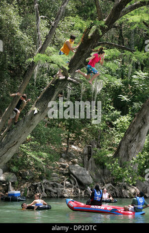 May 29, 2006; Gruene, TX, USA; River goers jump from a tree near Rockin' R River Rides into the Guadalupe River in Gruene, Texas that packed with young and old for Memorial Day Monday May 29, 2006. The three were given tickets by New Braunfels Police from the jump. Mandatory Credit: Photo by Kevin Geil/San Antonio Express-News/ZUMA Press. (©) Copyright 2006 by San Antonio Express-N Stock Photo