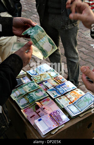 May 31, 2006; Arbil, Kurdistan, IRAQ; A man argues with a street money changer over a ripped Iraqi Dinar as he exchanges currency on the street in centre of Arbil, Jan 13. 2006. The region still deals mostly in a cash economy due to insufficient bank systems. Mandatory Credit: Photo by Sasa Kralj/JiwaFoto/ZUMA Press. (©) Copyright 2006 by JiwaFoto Stock Photo