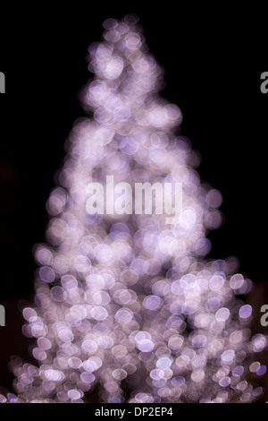 Defocused Christmas tree made of lights Stock Photo