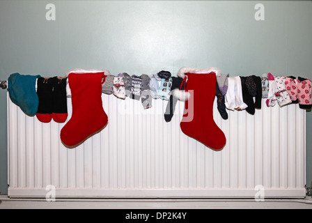 collection of socks drying on a radiator Stock Photo