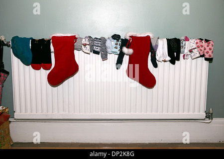 collection of socks drying on a radiator Stock Photo