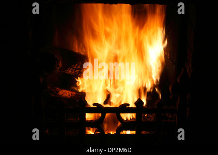 Fire in domestic hearth, heat flame flames heating fireside warmth fires grate burning wood coal home fires Stock Photo