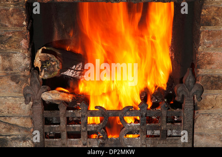 Fire in domestic hearth, heat flame flames heating fireside warmth fires grate burning wood coal home fires Stock Photo