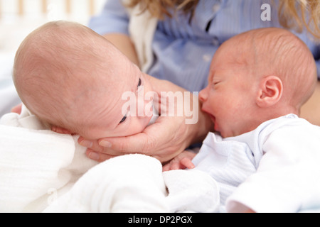 Mother and two week old twins Stock Photo