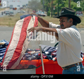 Jun 14, 2006; San Antonio, TX, USA; Henry Talamantes retires U.S. flags by burning Wednesday at the Dixie Flag Manufacturing Company.  Mandatory Credit: Photo by Tom Reel/San Antonio Express-News/ZUMA Press. (©) Copyright 2006 by San Antonio Express-News Stock Photo