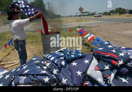 Jun 14, 2006; San Antonio, TX, USA; Henry Talamantes, an employee of Dixie Flag Manufacturing Company, retires United States Flags in front of the company facility on IH 35 North in San Antonio. Mandatory Credit: Photo by Tom Reel/San Antonio Express-News/ZUMA Press. (©) Copyright 2006 by San Antonio Express-News Stock Photo