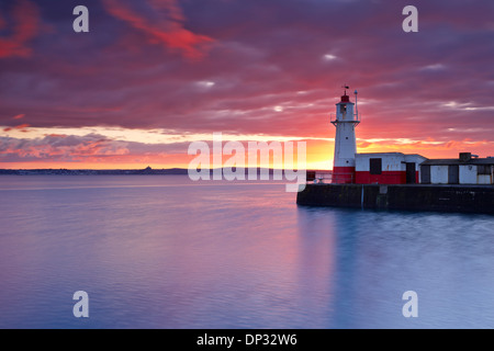 Sunrise over Newlyn Harbour Entrance and Mounts Bay Stock Photo