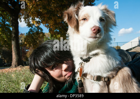A young woman and her dog in Williamsburg, NYC Stock Photo