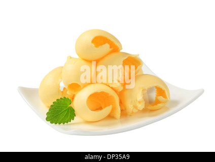 Curls of fresh butter on plate Stock Photo