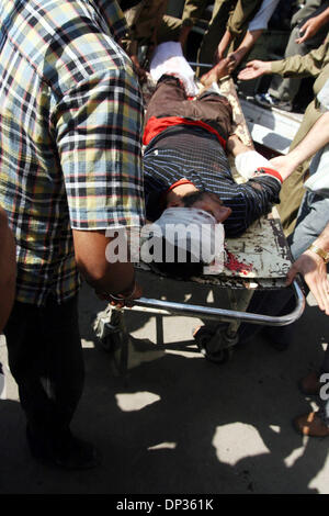 Jun 22, 2006; Spore, Kashmir, INDIA; Hospital staff and civilians rush a seriously wounded Kashmiri civilian for treatment to a local hospital, following a grenade blast in north Kashmir, in Srinagar, the summer capital of Indian Kashmir, 22 June, 2006. A hand grenade exploded Thursday during a sermon by a well-known Islamic religious leader addressing dozens of Muslim followers at Stock Photo