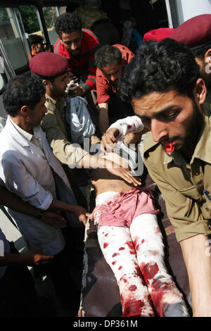 Jun 22, 2006; Spore, Kashmir, INDIA; Hospital staff and civilians rush a seriously wounded Kashmiri civilian for treatment to a local hospital, following a grenade blast in north Kashmir, in Srinagar, the summer capital of Indian Kashmir, 22 June, 2006. A hand grenade exploded Thursday during a sermon by a well-known Islamic religious leader addressing dozens of Muslim followers at Stock Photo